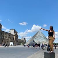 Student posing in front of the Louvre